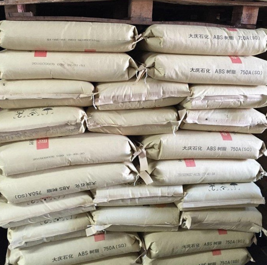 Warehouse-stacked-pallets-of-Kunlun-Daqing-750A-SQ-ABS-plastic-raw-material-sacks-bulk-stock